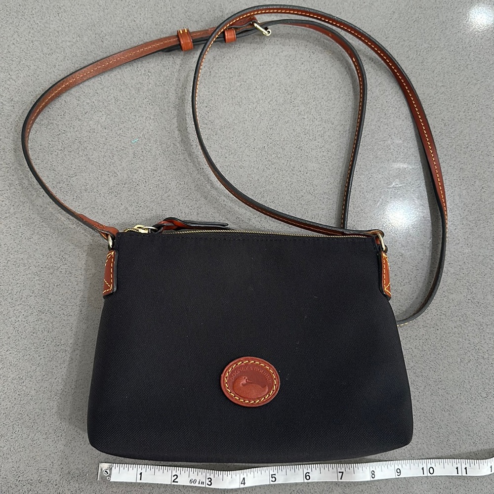 Dooney & Bourke Canvas Black/tan Crossbody with red interior.